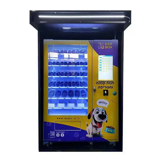 Yellow outdoor pet food vending machine with illuminated shelves and cartoon dog graphic, dispensing pet supplies.